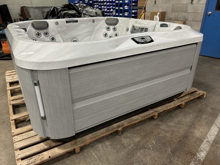 Jacuzzi J-355 hot tub model UJ100891132 exterior front view in light cabinet finish on showroom floor