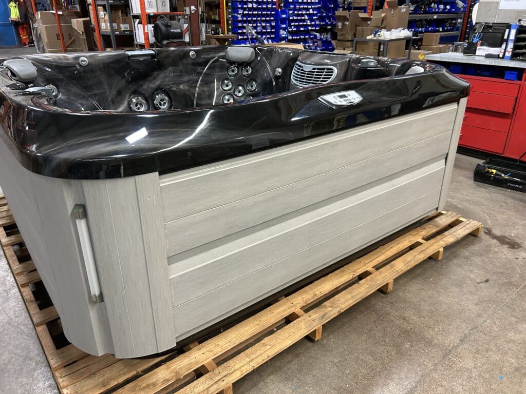 Jacuzzi® J-385 hot tub UJ100925144 exterior front view in showroom