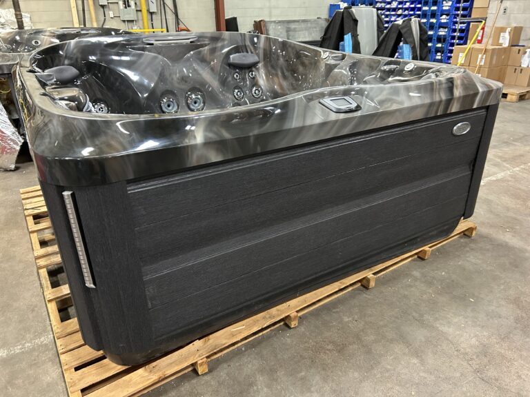 Jacuzzi J-475 hot tub front exterior with dark cabinetry and waterfall feature housing