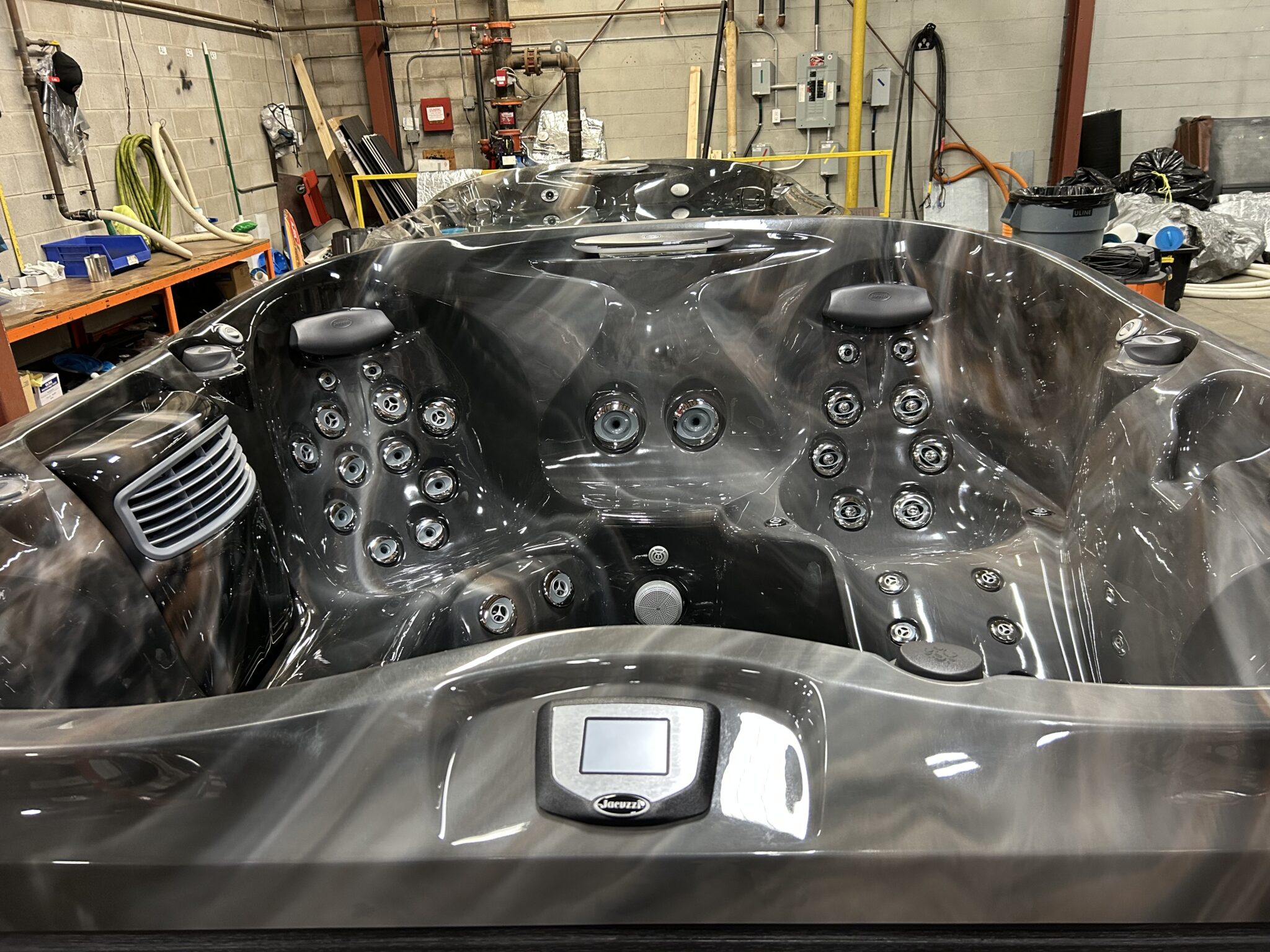 Jacuzzi J-475 hot tub interior front view showing ergonomic seating and hydrotherapy jet layout